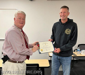 Chief Eddie Ruch Jr. receives the award from CCDFEMS Director Michael Robinson